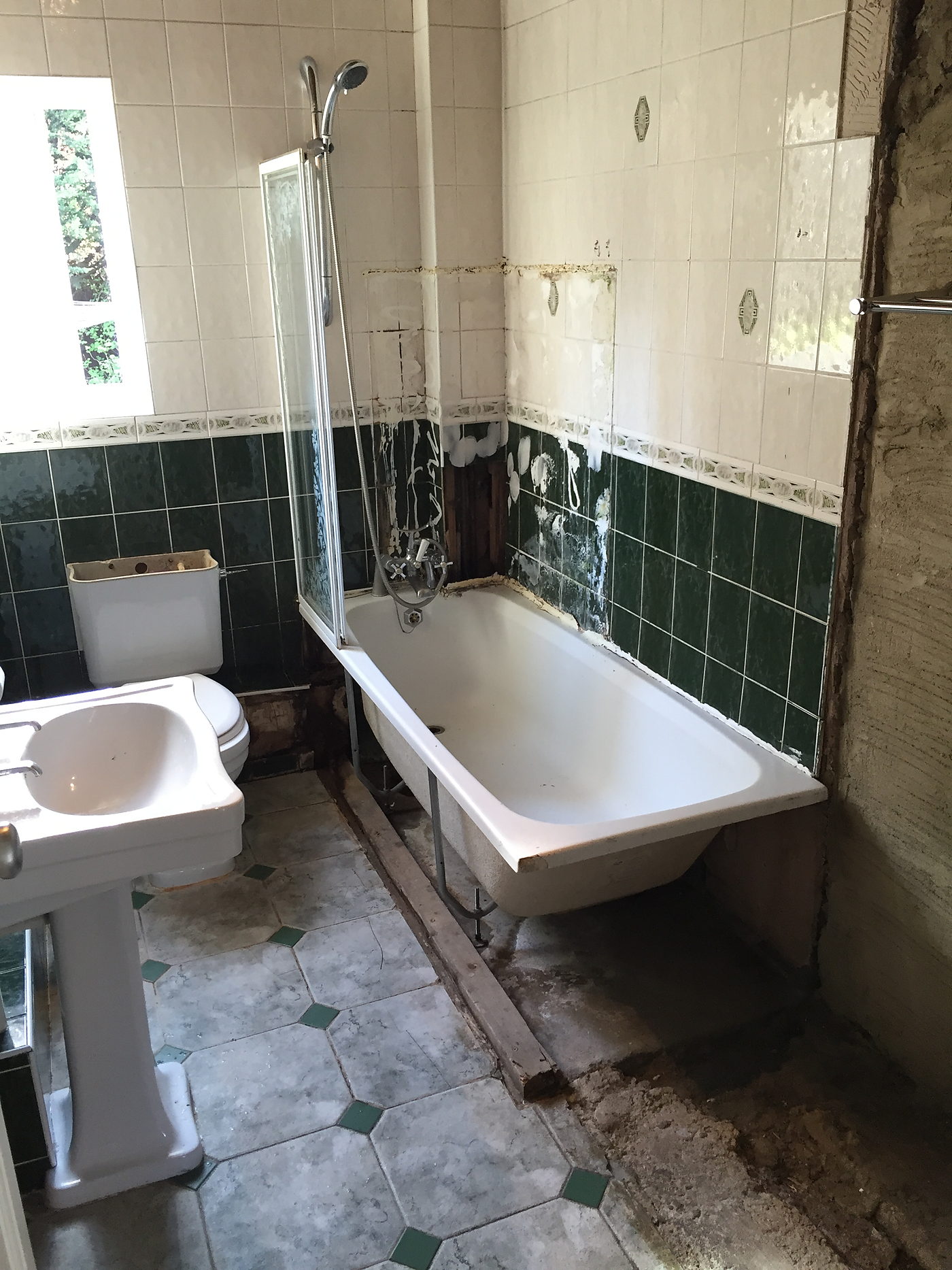 Old green tiled bathroom before the refit