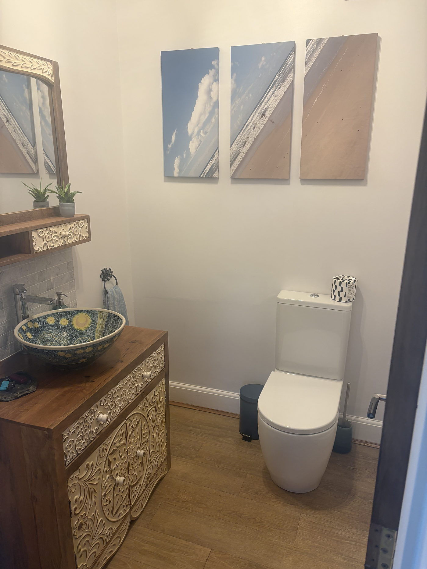 Cloakroom with a counter top basin on a carved wooden unit