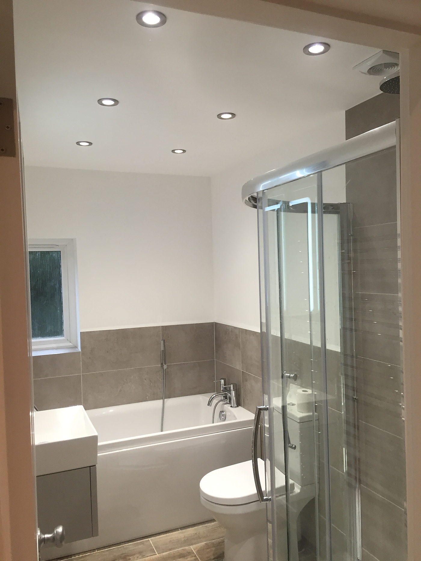 Downlights and a shower enclosure in a finished bathroom