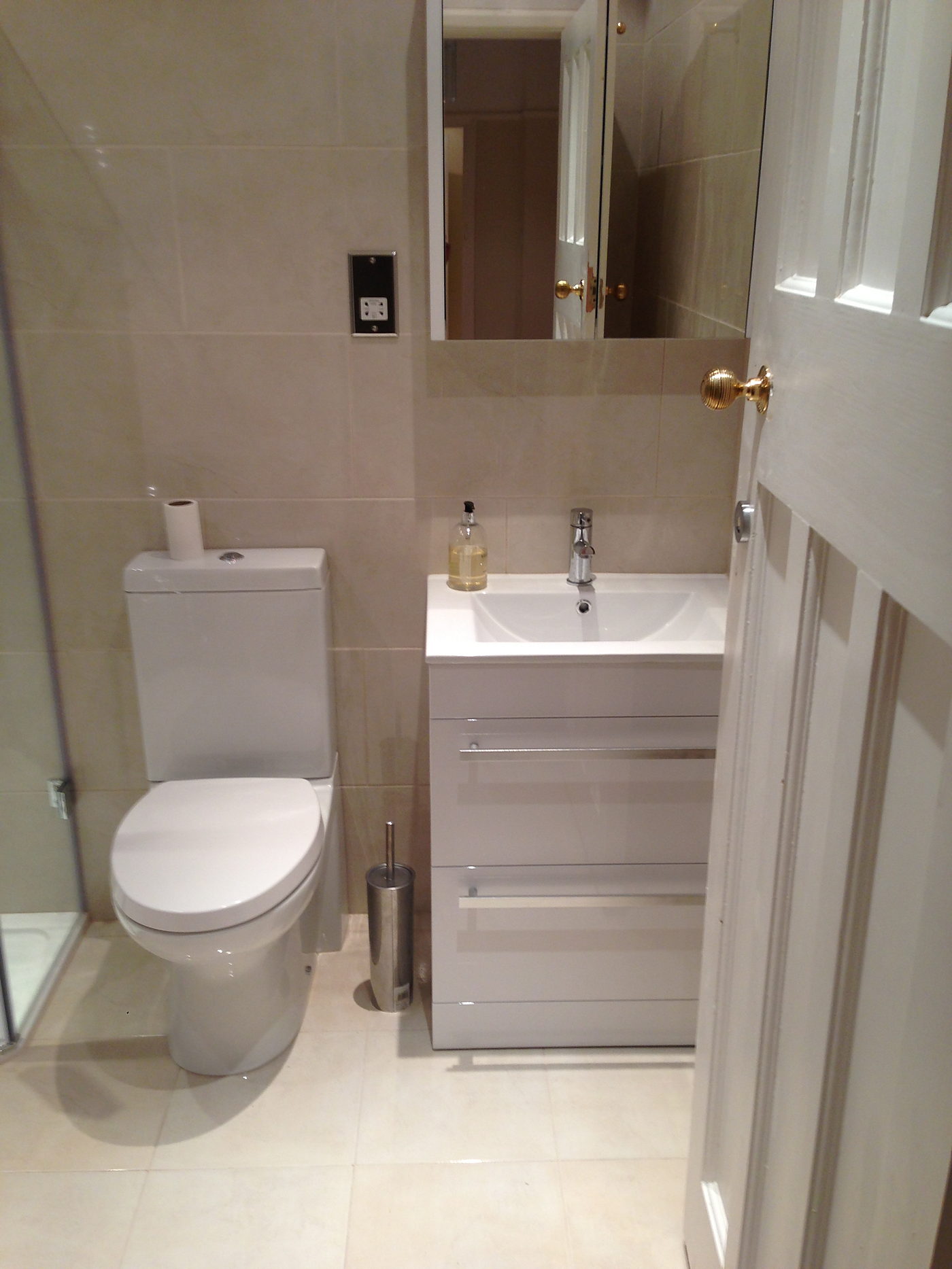 Compact bathroom with a WC, basin unit and tiled walls