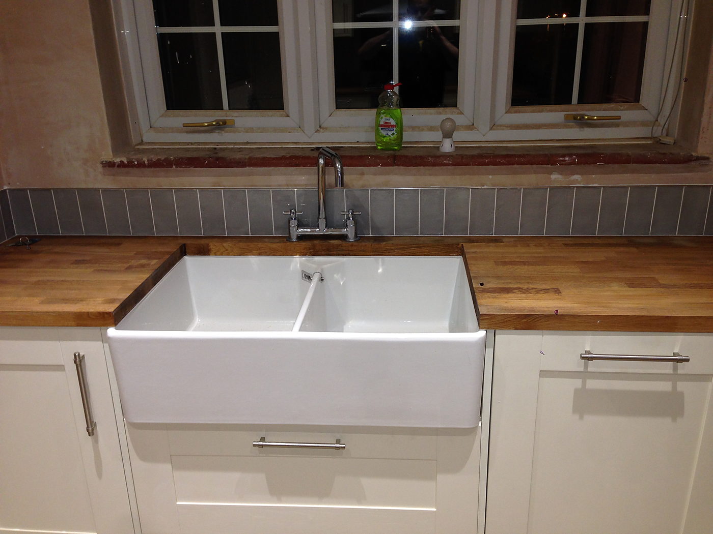 Butler sink and oak worktop in a finished kitchen