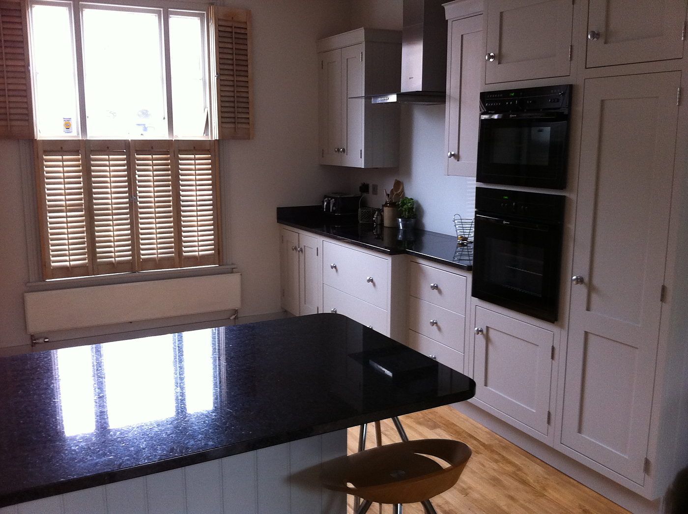 Kitchen diner with a granite topped island and shuttered windows