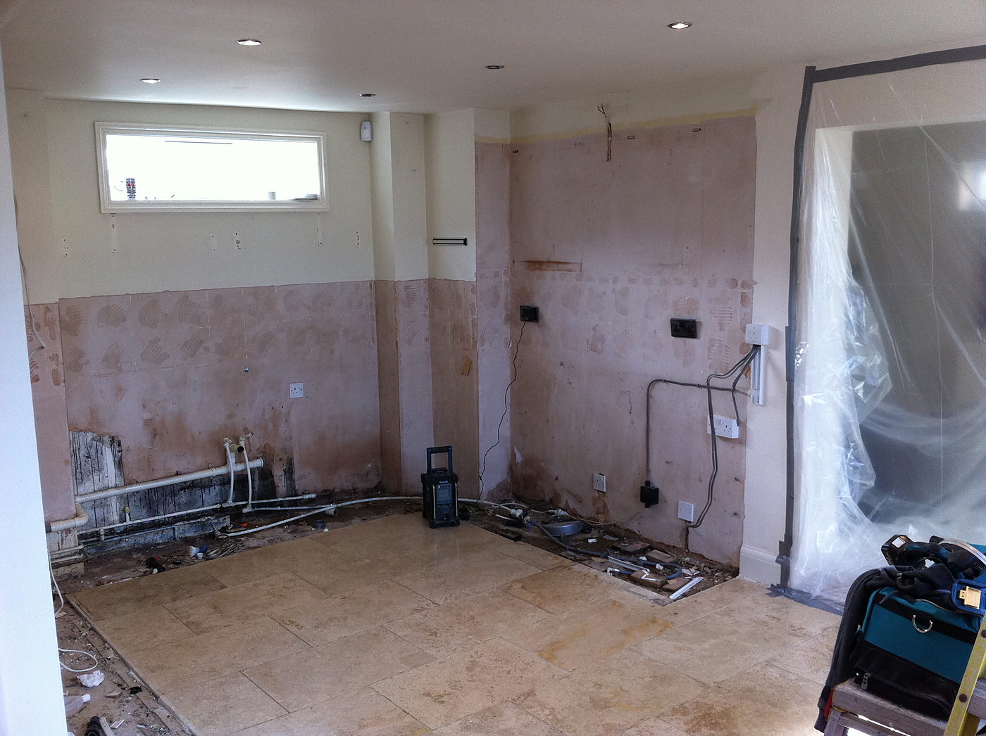 Kitchen stripped back to bare walls before a refit