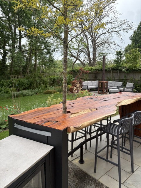 Garden bar with stools looking out over the lawn