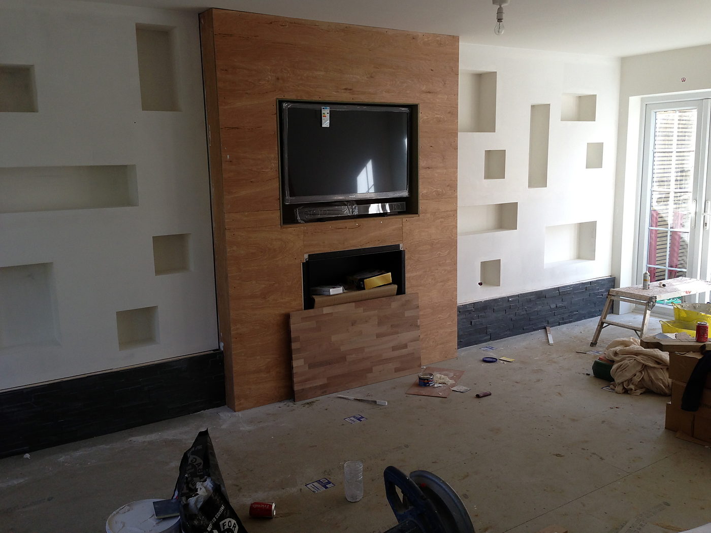 Media wall with a television and inset display niches