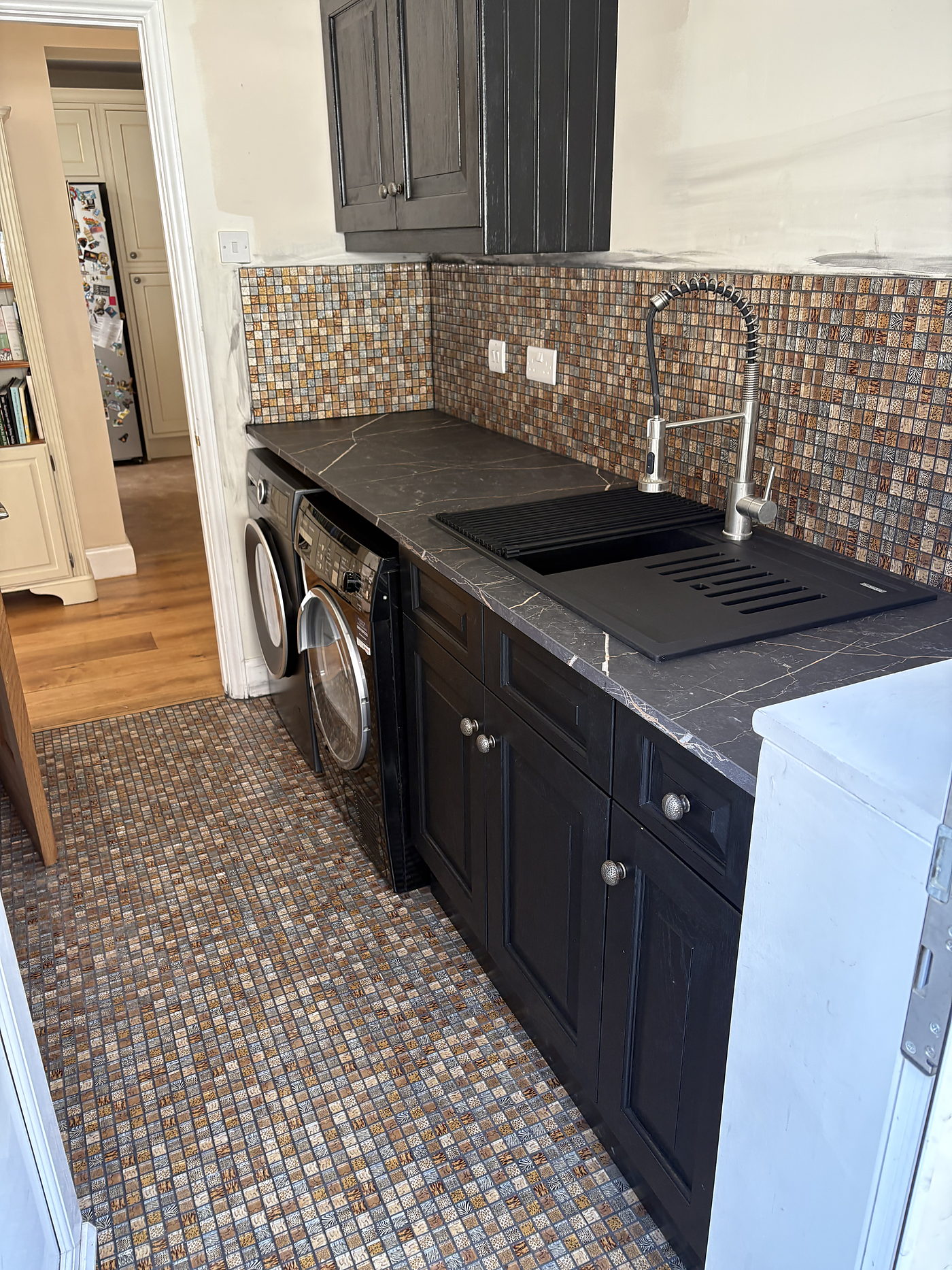 Sockets and a switch above the worktop in a finished utility room